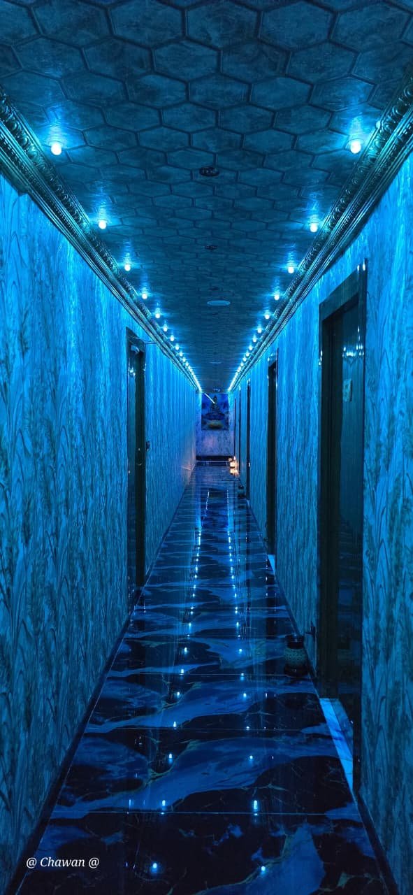 Electric blue illuminated corridor at Phoenix International Spa Whitefield Bengaluru