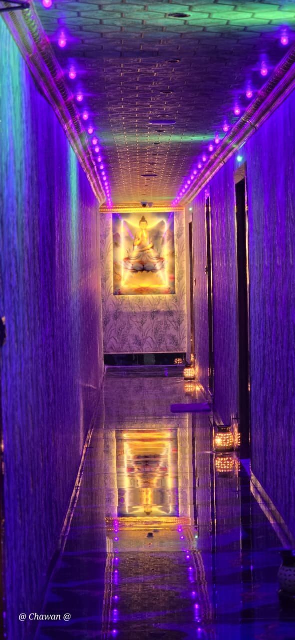 Purple-lit corridor with Buddha artwork at Phoenix International Spa