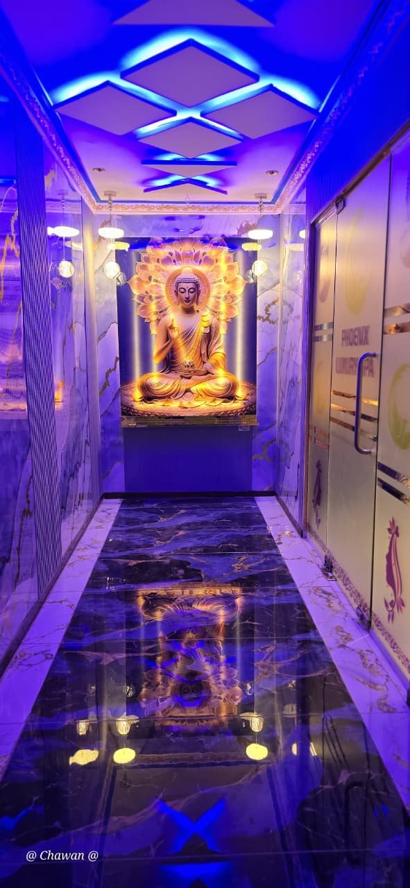 Entrance corridor with illuminated Buddha statue at Phoenix International Spa Whitefield