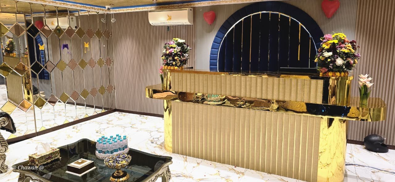 Gold reception desk at Phoenix International Spa with flower arrangements